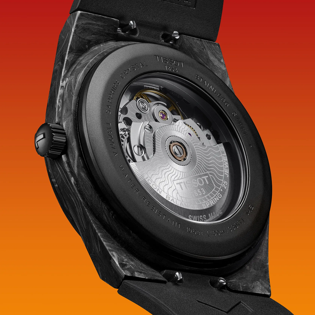 Tissot PRX Carbon 40.5mm watch on a colored background, reference T137.907.97.201.00