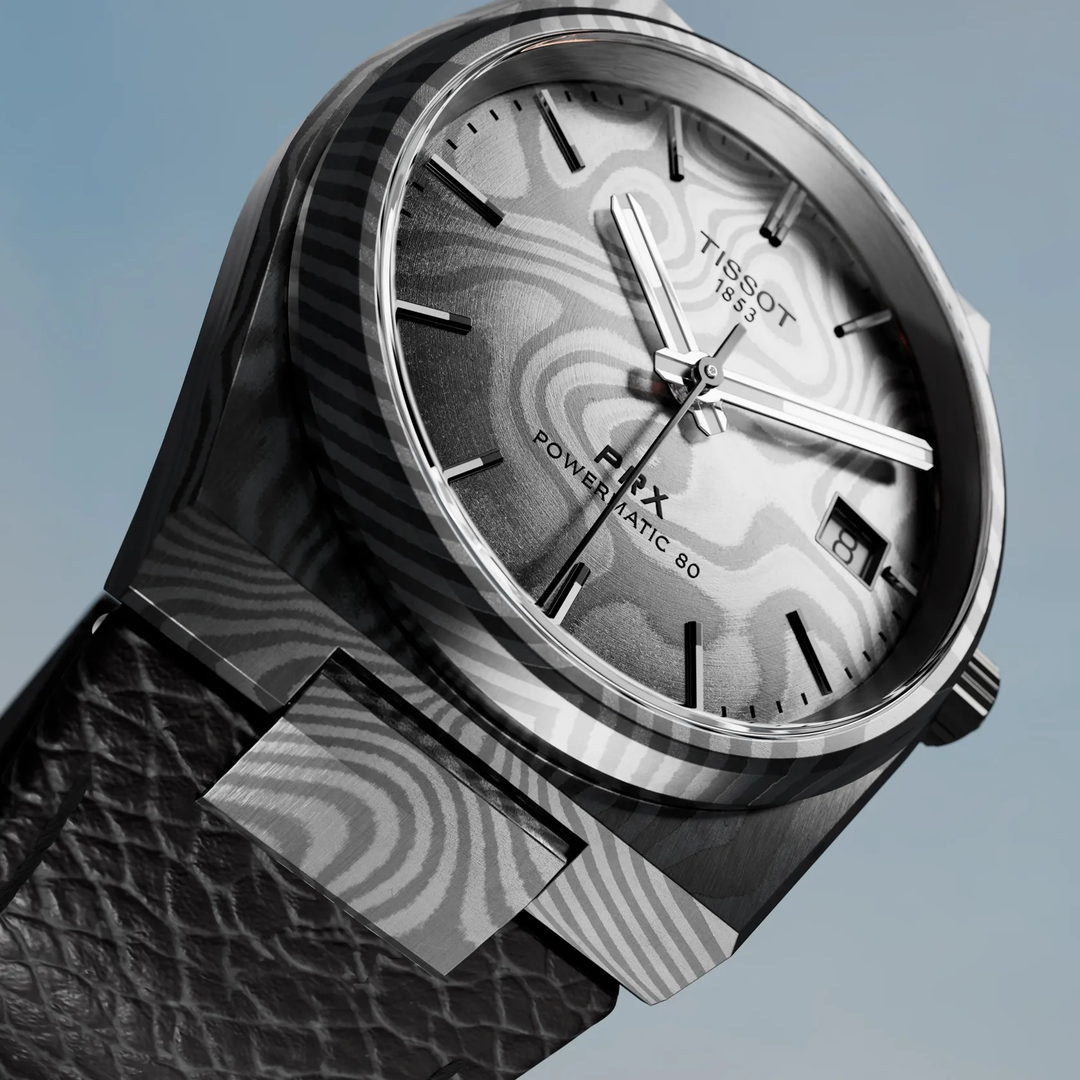 Tissot PRX Damascus Steel 38mm watch on a colored background, reference T137.807.96.081.00