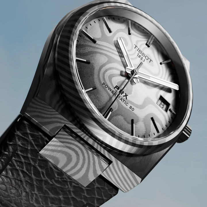 Tissot PRX Damascus Steel 38mm watch on a colored background, reference T137.807.96.081.00