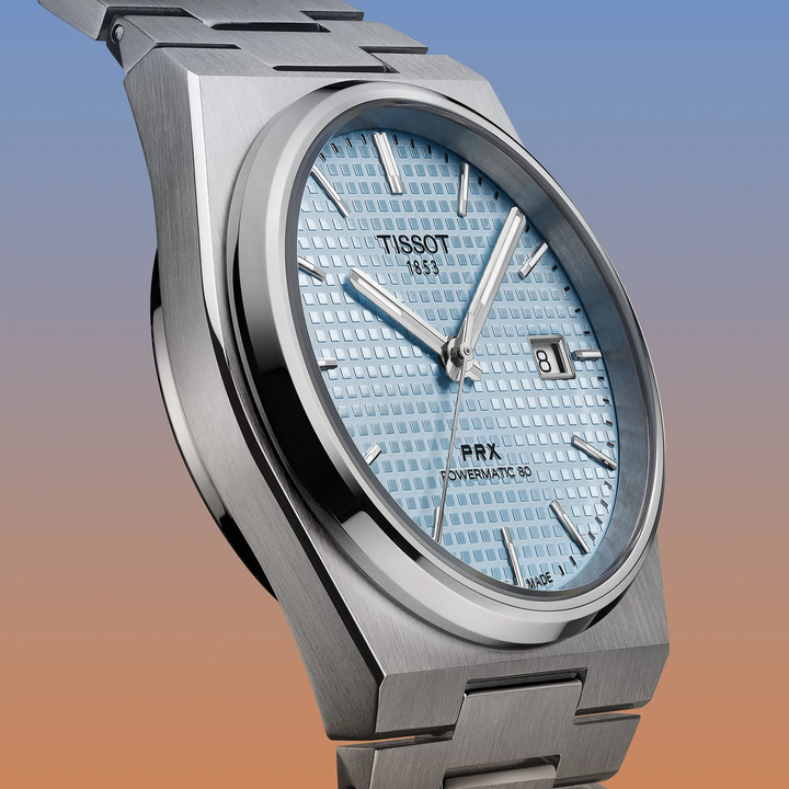 Tissot PRX 35mm watch on a colored background, reference T137.210.11.041.00