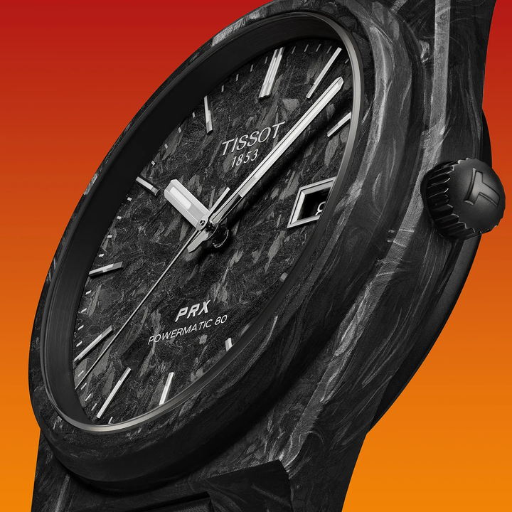 Tissot PRX Carbon 40.5mm watch on a colored background, reference T137.907.97.201.00