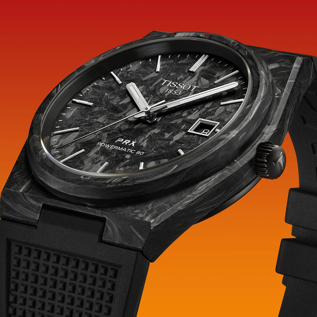 Tissot PRX Carbon 40.5mm watch on a colored background, reference T137.907.97.201.00