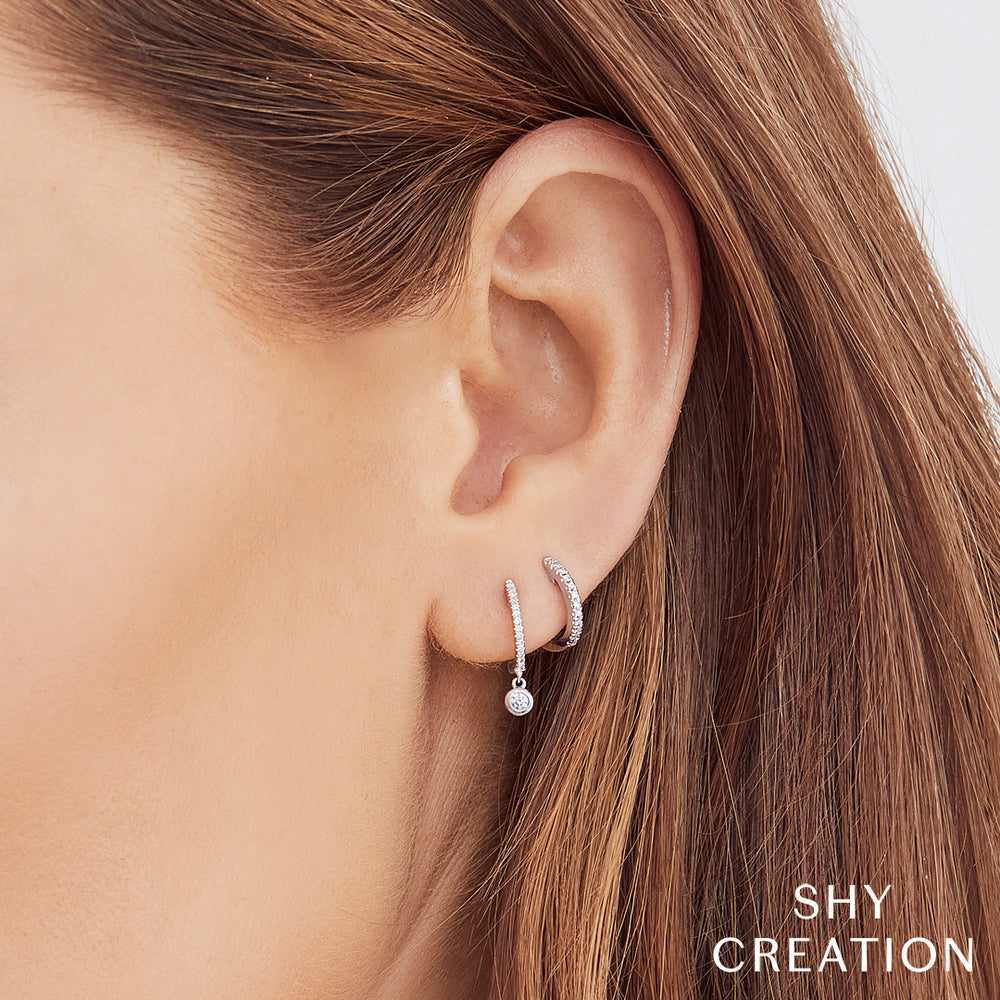 Shy Creation 0.07 ct Diamond Huggie Earrings in 14K White Gold — SC22003982 — styled with other jewellery; additional pieces sold separately
