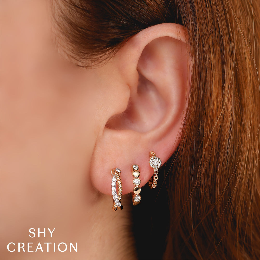 Shy Creation 0.21 ct Diamond Twisted Hoop Earrings in 14K Yellow Gold — styled with other jewellery; additional pieces sold separately — SC55026858RDD0.60