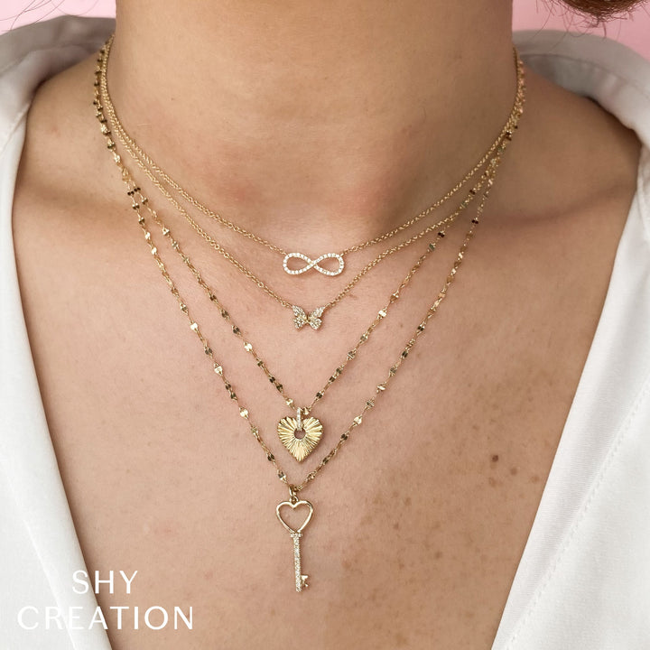 Shy Creation 0.09 ct Diamond Infinity Necklace in 14K Yellow Gold — styled with other jewellery; additional pieces sold separately — SC55001539V2