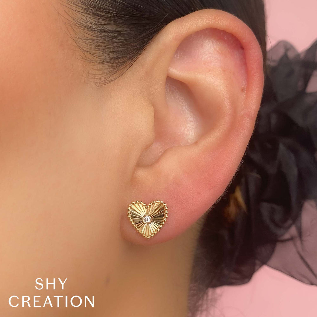 Shy Creation 0.04 ct Diamond Bezel Ribbed Heart Stud Earrings in 14K Yellow Gold — styled with other jewellery; additional pieces sold separately — SC55026093