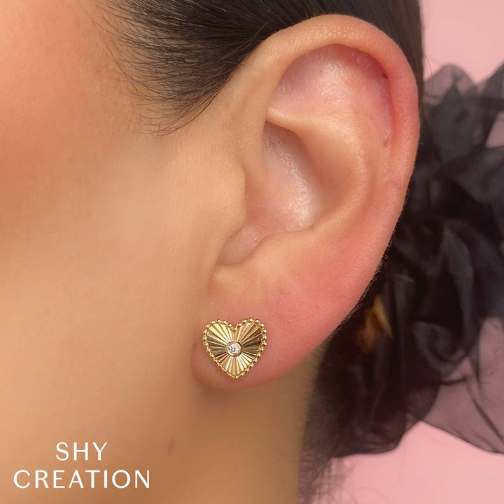 Shy Creation 0.04 ct Diamond Bezel Ribbed Heart Stud Earrings in 14K Yellow Gold — styled with other jewellery; additional pieces sold separately — SC55026093