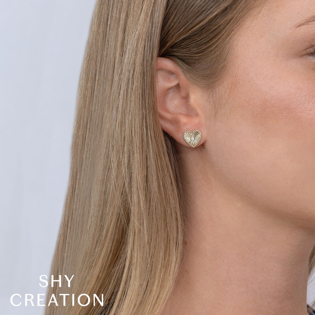 Shy Creation 0.04 ct Diamond Bezel Ribbed Heart Stud Earrings in 14K Yellow Gold — styled with other jewellery; additional pieces sold separately — SC55026093