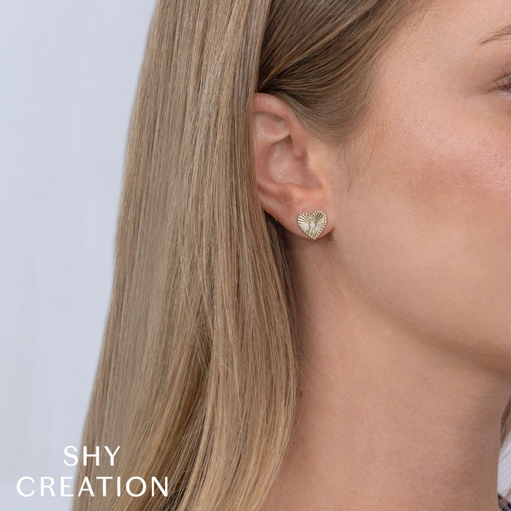 Shy Creation 0.04 ct Diamond Bezel Ribbed Heart Stud Earrings in 14K Yellow Gold — styled with other jewellery; additional pieces sold separately — SC55026093