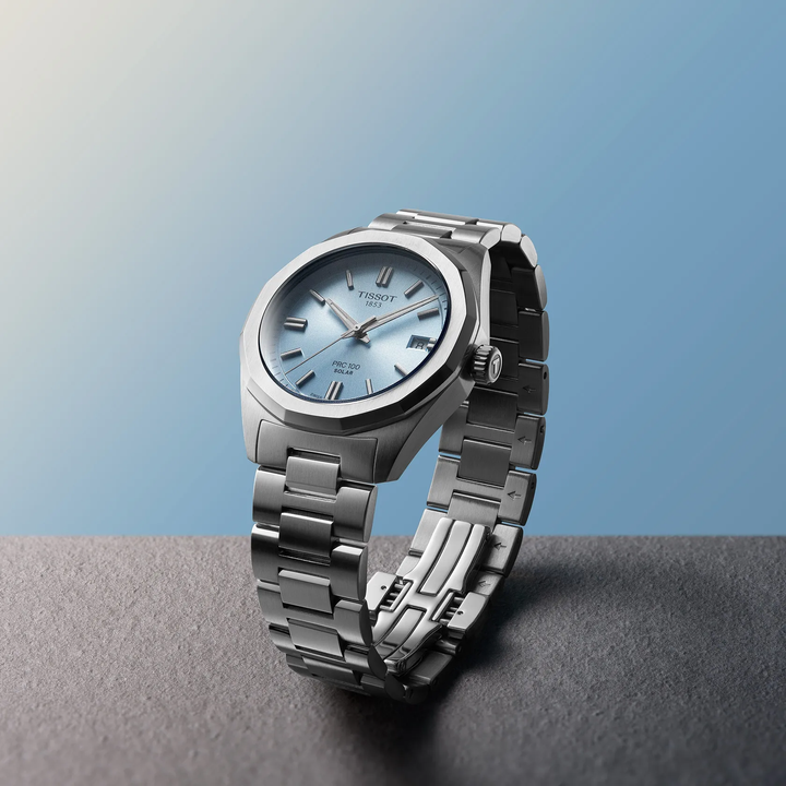 Tissot PRC 100 Solar 34mm watch on a colored background, reference T151.822.11.351.00