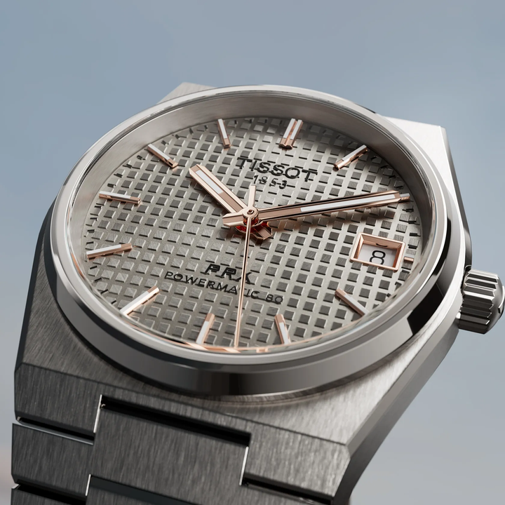Tissot PRX Titanium 38mm watch on a colored background, reference T137.807.44.061.00
