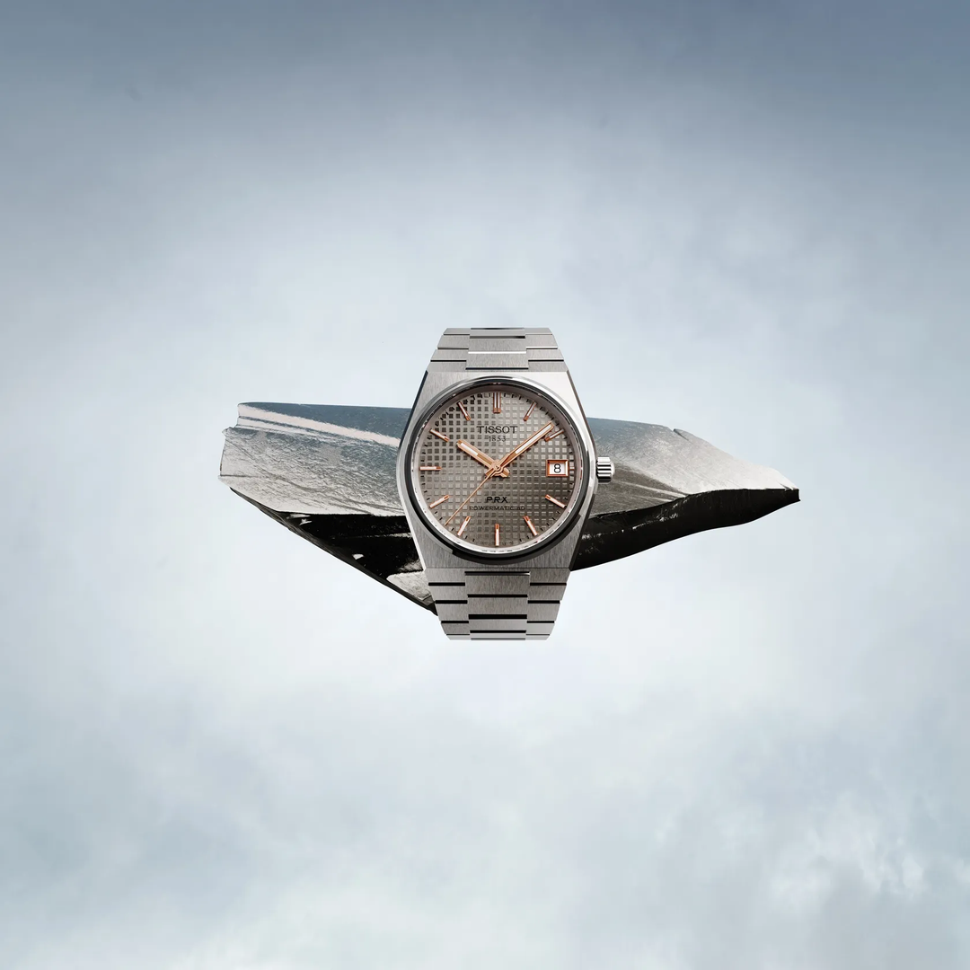 Tissot PRX Titanium 38mm watch on a colored background, reference T137.807.44.061.00