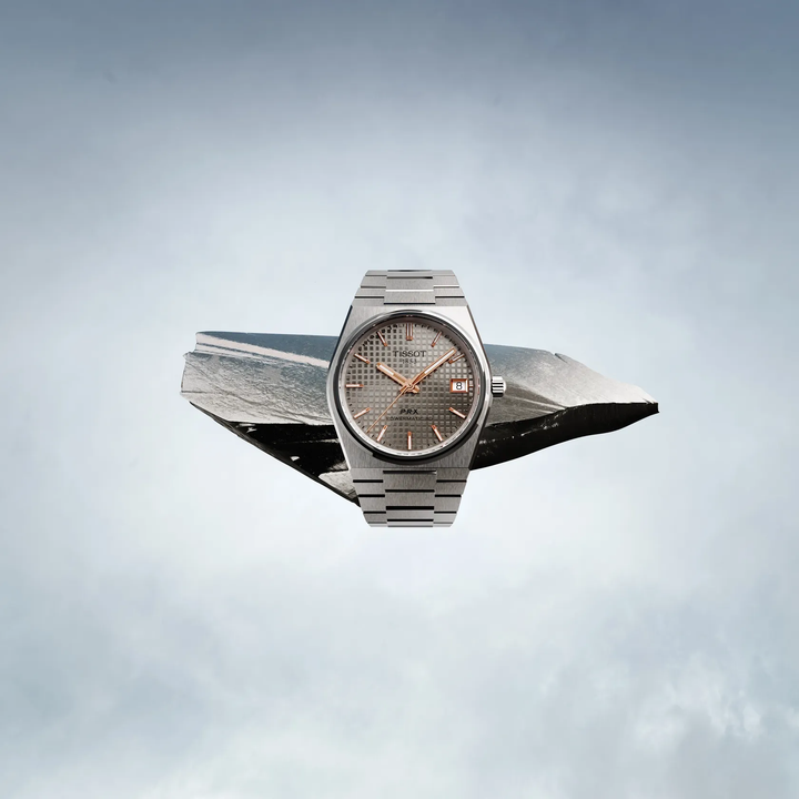 Tissot PRX Titanium 38mm watch on a colored background, reference T137.807.44.061.00