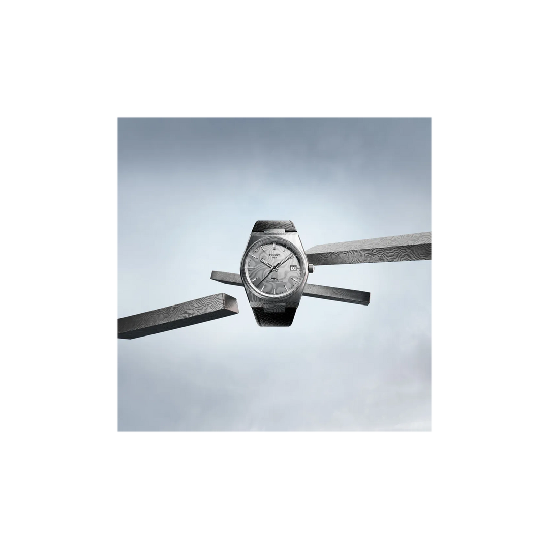 Tissot PRX Damascus Steel 38mm watch on a colored background, reference T137.807.96.081.00